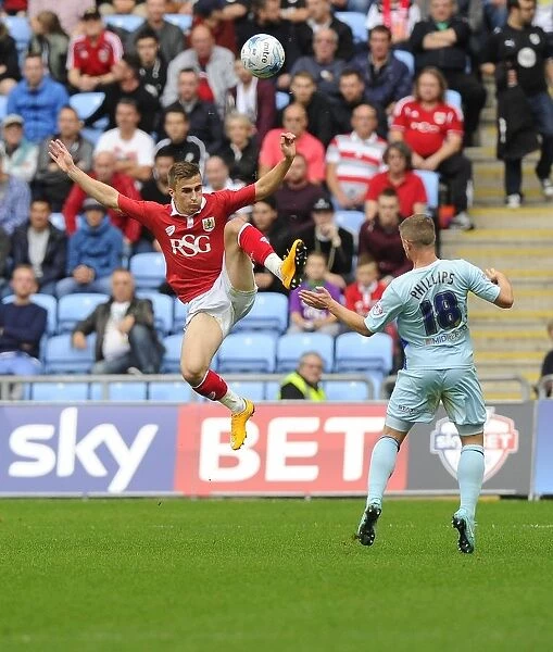 Battling for Supremacy: Joe Bryan vs. Aaron Phillips in Bristol City's Sky Bet League One Clash at Ricoh Arena