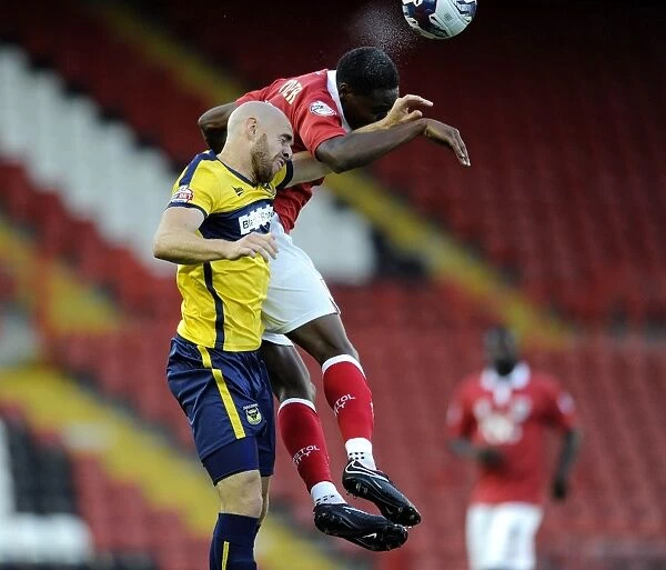 Bristol City's Jordan Wynter Outmuscles Oxford United's Tom Newey for the Ball in Capital One Cup Clash