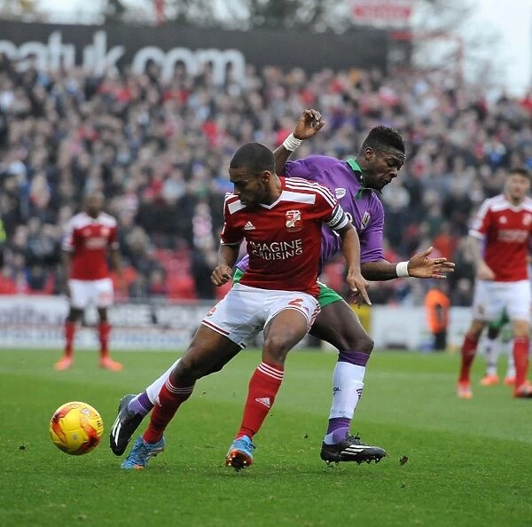 Bristol City's Kieran Agard Closes In on Swindon Town's Nathan Thompson in Sky Bet League One Clash