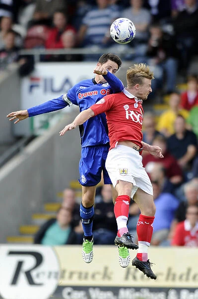 Ian Henderson Clashes Heads with Wade Elliott in Rochdale vs. Bristol City Football Match, 2014