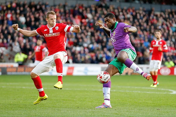 Intense Rivalry: Peter Ramage Stands Firm Against Jay Emmanuel-Thomas's Charge (Barnsley vs. Bristol City, Football)