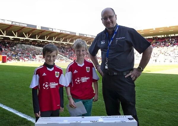 Through Their Joy: Young Fans Luca Fortuna and Leo Worlock Receive Football Prize after an Exciting Match at Ashton Gate (Bristol City v Notts County, 2014)