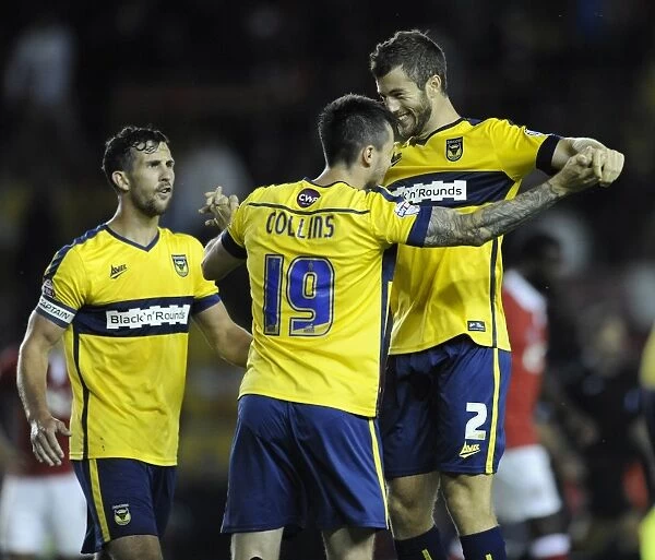 Oxford United's Upset Victory: Jonathan Meades and Michael Collins Celebrate Overpowering Bristol City