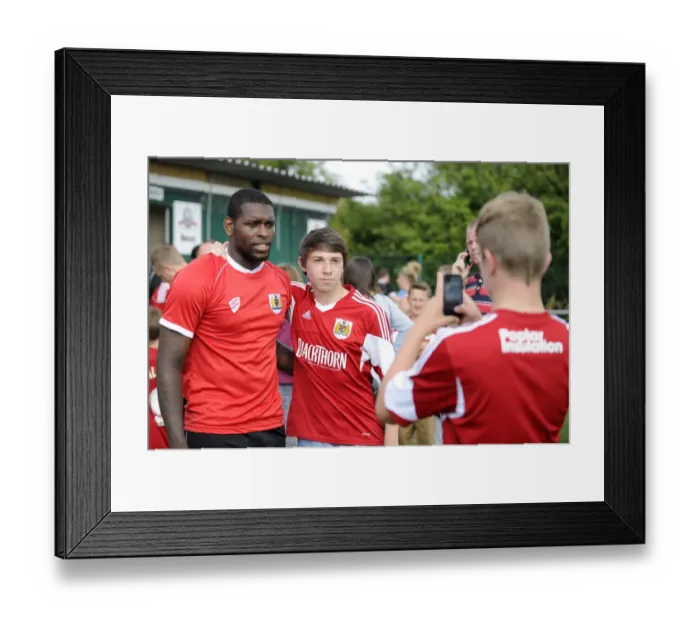 Framed Print : Bristol City Fan Amidst Pre-Season Action at Portishead Town's The Playing Fields Framed Print : Bristol City Fan Amidst Pre-Season Action at Portishead Town's The Playing Fields