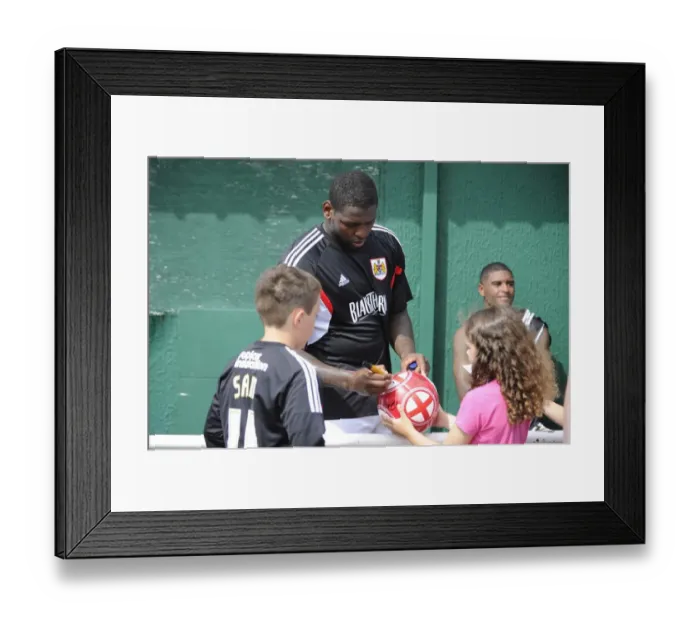 Framed Print : Bristol City's Jay Emmanuel-Thomas Signs Football at Portishead Town Pre-Season Friendly