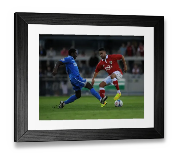 Framed Print : Derrick Williams vs Jake Mawford: Intense Clash in Pre-Season Friendly between Weston-super-Mare and Bristol City