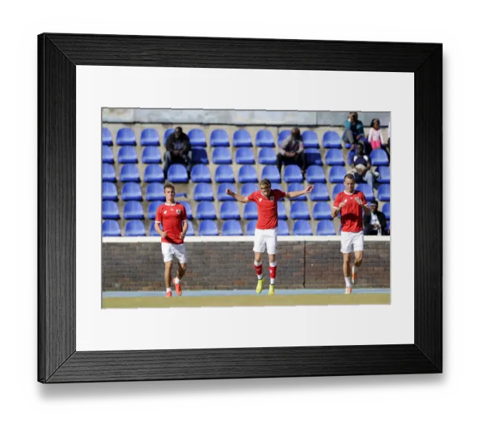 Framed Print : Bristol City Footballers Joe Bryan, Wes Burns, and Aaron Wilbraham Warm Up Ahead of Extension Gunners Match, 2014