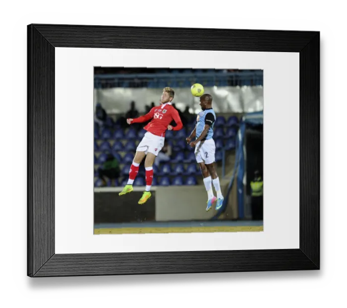 Framed Print : Bristol City's Wes Burns Battles for the Header in Botswana Tour Match Framed Print : Bristol City's Wes Burns Battles for the Header in Botswana Tour Match