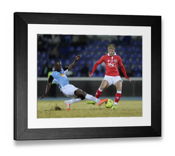 Framed Print : Bristol City's Wes Burns Tackled During Botswana Tour Match Framed Print : Bristol City's Wes Burns Tackled During Botswana Tour Match