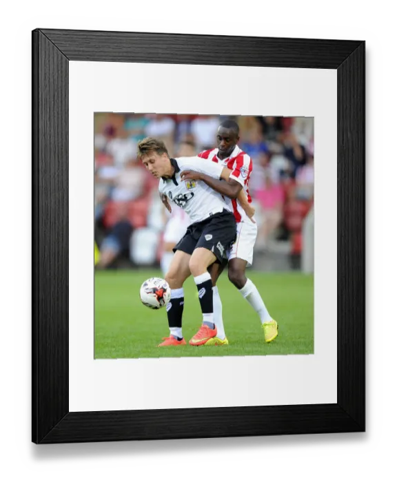 Framed Print : Battle for Control: Luke Freeman vs. Omari Sterling-James in the Cheltenham Town Clash (July 2014)