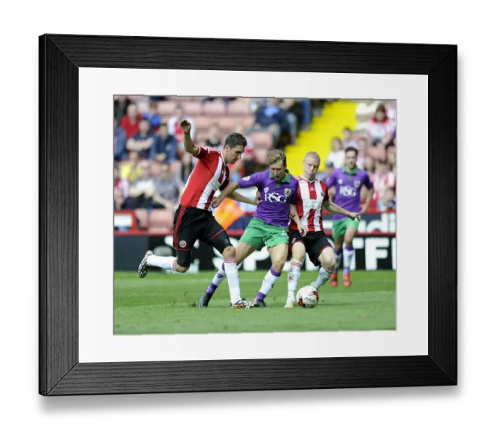 Framed Print : Sheffield United vs. Bristol City: Intense Battle Between Luke Freeman and New Signings Chris Basham and Craig Alcock