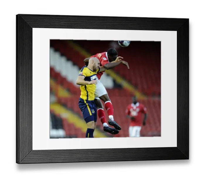 Framed Print : Bristol City's Jordan Wynter Outmuscles Oxford United's Tom Newey for the Ball in Capital One Cup Clash