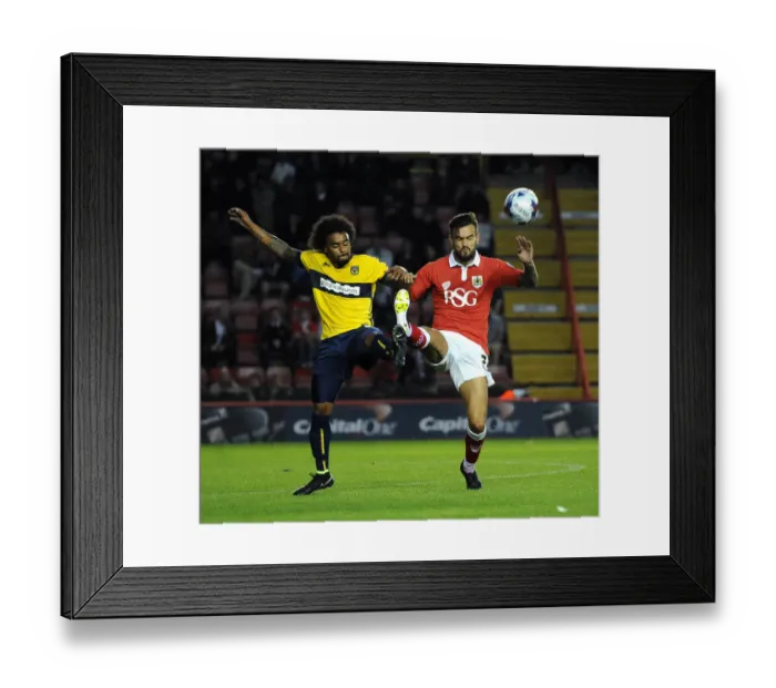 Framed Print : Bristol City vs Oxford United: Marlon Pack and Junior Brown Battle for Control