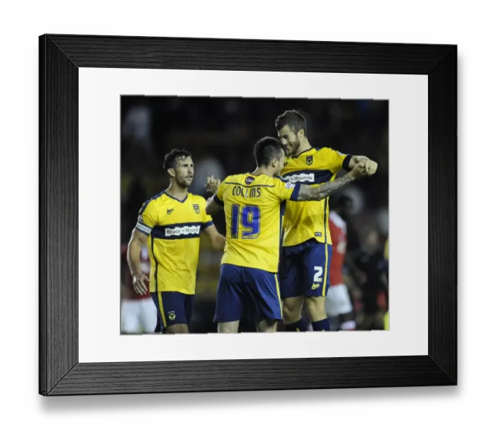 Framed Print : Oxford United's Upset Victory: Jonathan Meades and Michael Collins Celebrate Overpowering Bristol City