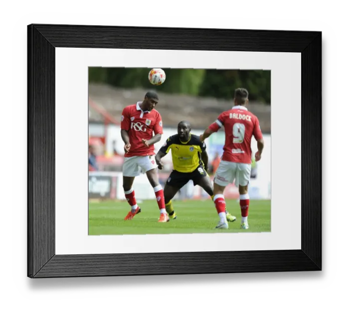 Framed Print : Mark Little Wins Aerial Battle Against Jabo Ibehre in Bristol City vs Colchester United Football Match, 2014 Framed Print : Mark Little Wins Aerial Battle Against Jabo Ibehre in Bristol City vs Colchester United Football Match, 2014