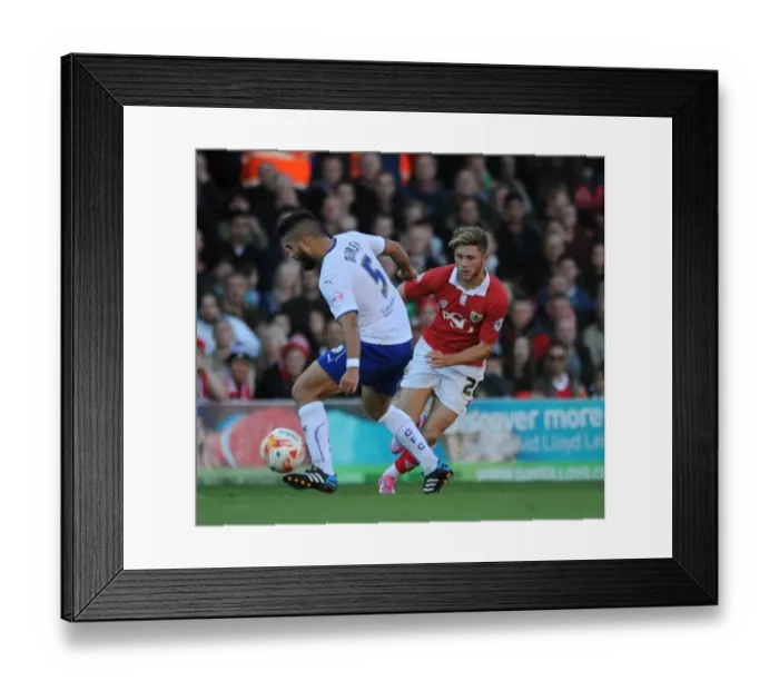 Framed Print : Bristol City's Wes Burns Evades Sam Morsy in Sky Bet League One Clash Framed Print : Bristol City's Wes Burns Evades Sam Morsy in Sky Bet League One Clash