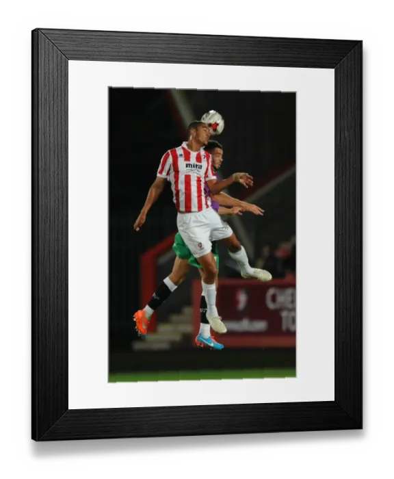 Framed Print : Derrick Williams vs Byron Harrison: Intense Battle for the Ball in Cheltenham Town vs Bristol City Football Match, October 2014 Framed Print : Derrick Williams vs Byron Harrison: Intense Battle for the Ball in Cheltenham Town vs Bristol City Football Match, October 2014