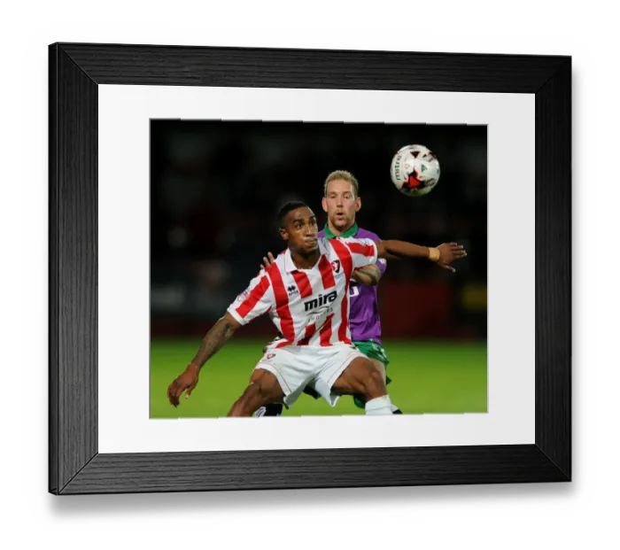 Framed Print : Scott Wagstaff Chases Down Craig Braham-Barrett in Johnstone's Paint Trophy Clash: Intense Moment at Abbey Business Stadium