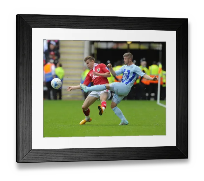 Framed Print : Battling for Control: Joe Bryan vs. Aaron Phillips in Sky Bet League One Clash at Ricoh Arena