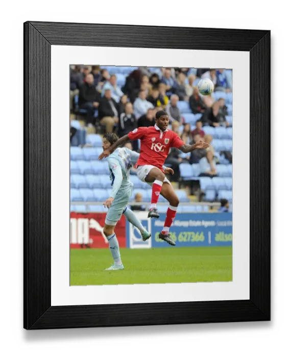 Framed Print : Battling for the High Ball: Mark Little vs. Adam Barton - Sky Bet League One Clash