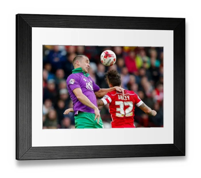 Framed Print : Intense Aerial Battle: Wilbraham vs Bailey at Oakwell Stadium - Football Rivalry in the Sky Framed Print : Intense Aerial Battle: Wilbraham vs Bailey at Oakwell Stadium - Football Rivalry in the Sky