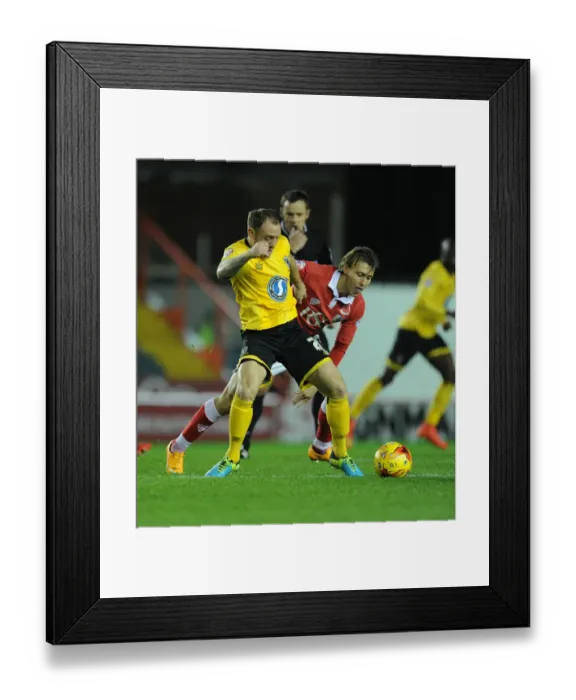 Framed Print : Battling for Supremacy: Osborne vs. Fuller in the Johnstone's Paint Trophy Clash between Bristol City and AFC Wimbledon