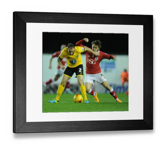 Framed Print : Tense Moment: Osborne Holds Back Fuller in Bristol City vs AFC Wimbledon Match Framed Print : Tense Moment: Osborne Holds Back Fuller in Bristol City vs AFC Wimbledon Match
