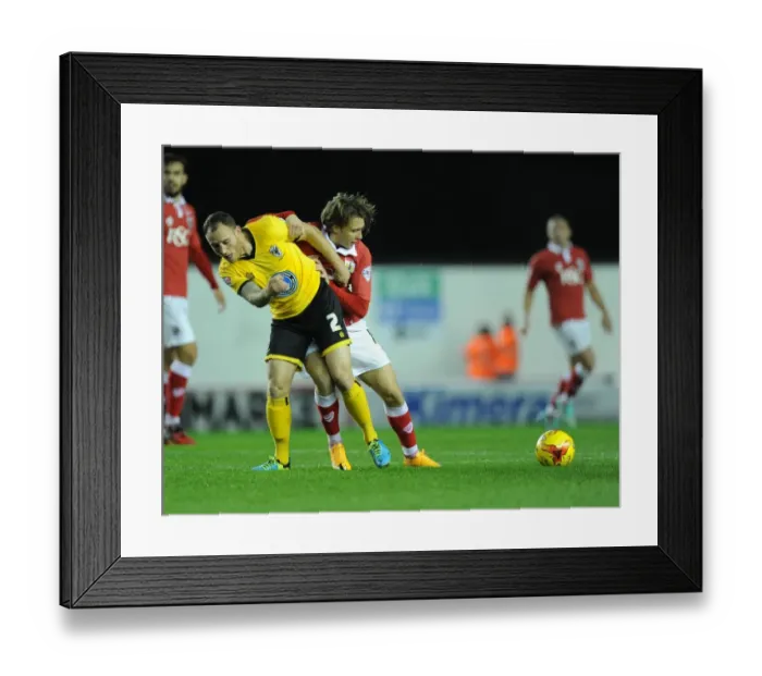 Framed Print : Osborne vs Fuller: A Tense Moment at Ashton Gate - Bristol City vs AFC Wimbledon