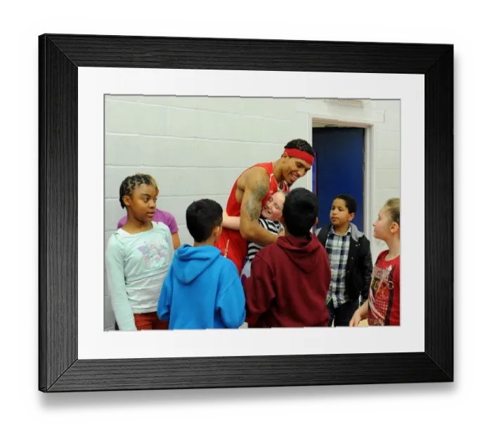 Framed Print : Bristol Flyers Basketball: Greg Streete Embraces Young Fan Amidst Cheers at Wise Campus