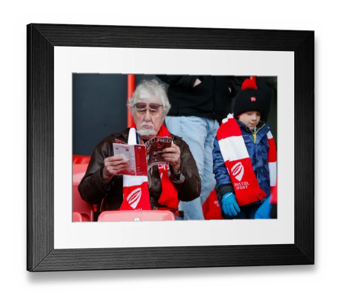 Framed Print : Bristol City Fan Absorbed in Match Program before FA Cup Clash vs. West Ham United Framed Print : Bristol City Fan Absorbed in Match Program before FA Cup Clash vs. West Ham United