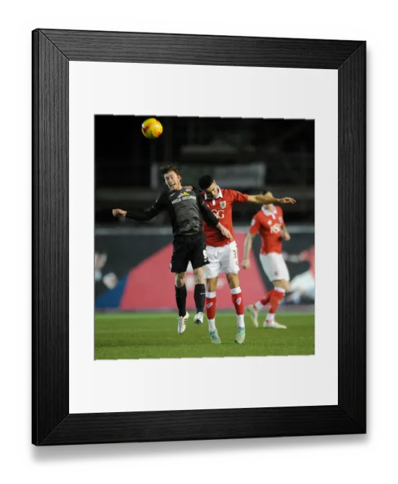 Framed Print : Intense Header Battle: Derrick Williams vs Luke James in Bristol City vs Peterborough United