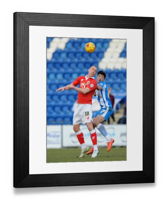 Framed Print : Intense Aerial Battle: Wilbraham vs. Bonne in Colchester United vs. Bristol City Football Match, 2015