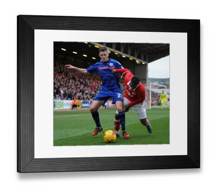 Framed Print : Bristol City vs Rochdale: Intense Moment as Kieran Agard Fights for the Ball with Jack O'Connell
