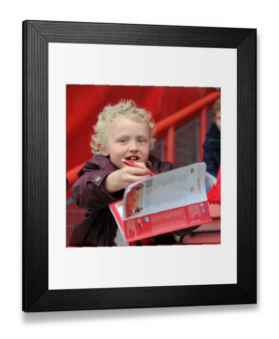 Framed Print : Young Fan Seeks Player Autographs at Ashton Gate Stadium before Bristol City vs Barnsley Match Framed Print : Young Fan Seeks Player Autographs at Ashton Gate Stadium before Bristol City vs Barnsley Match