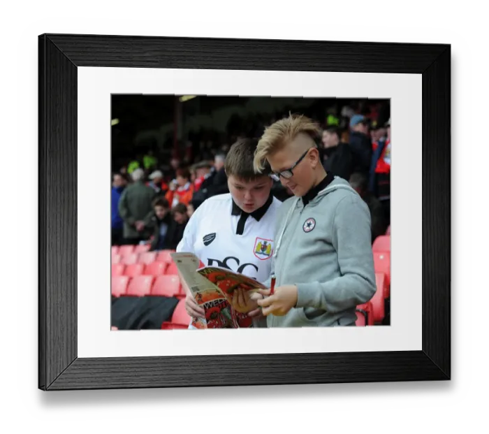 Framed Print : Bristol City Fans Preview Match Program Before Barnsley Clash at Ashton Gate Stadium Framed Print : Bristol City Fans Preview Match Program Before Barnsley Clash at Ashton Gate Stadium