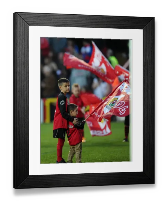 Framed Print : Young Flag Bearers Assisting Each Other at Bristol City vs Swindon Town Match, April 2015