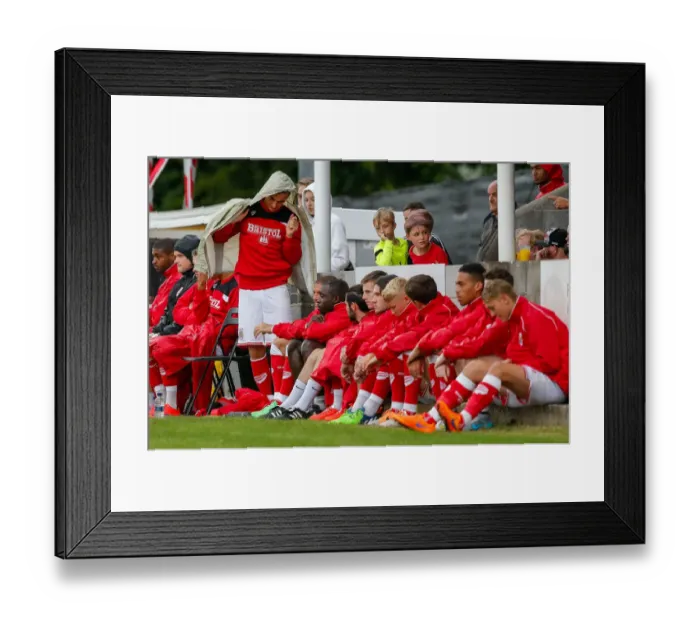 Framed Print : Bristol City's Joe Bryan Shields Himself from the Rain during Pre-Season Community Match Framed Print : Bristol City's Joe Bryan Shields Himself from the Rain during Pre-Season Community Match