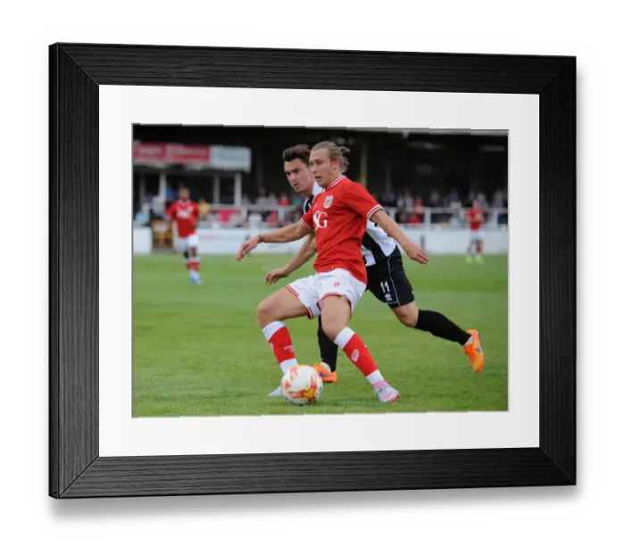 Framed Print : Bristol City's Luke Freeman Faces Off Against Bath City's Ash Kington in Pre-Season Friendly