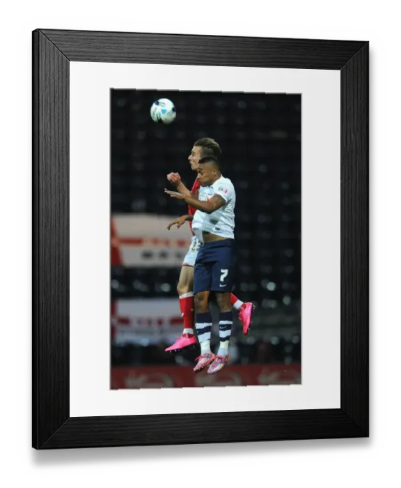 Framed Print : Intense Aerial Clash: Joe Bryan vs Chris Humphrey at Deepdale Stadium Framed Print : Intense Aerial Clash: Joe Bryan vs Chris Humphrey at Deepdale Stadium