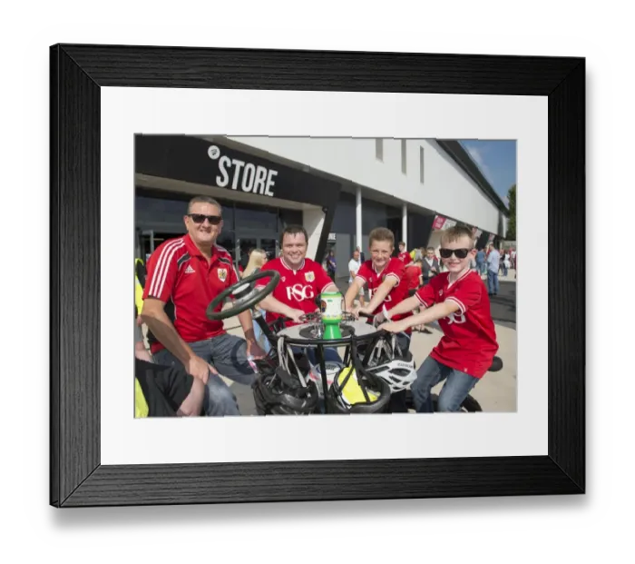 Framed Print : Bristol City Fans Gather Around Children's Hospice South West's Seven-Seater Bike at Ashton Gate Stadium Framed Print : Bristol City Fans Gather Around Children's Hospice South West's Seven-Seater Bike at Ashton Gate Stadium
