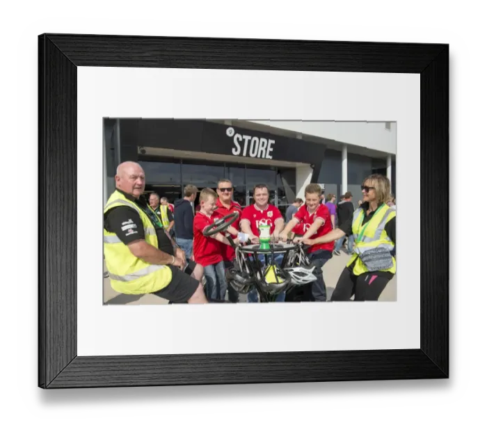 Framed Print : Bristol City Fans Ride for a Cause: Seven-Seater Bike Demonstration at Ashton Gate Stadium for Children's Hospice South West