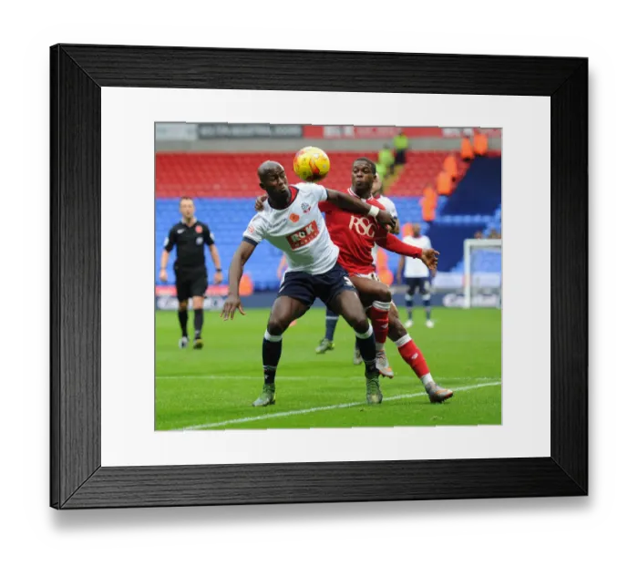 Framed Print : Kieran Agard Closes In: Intense Moment as Agard Harasses Gouano in Bolton vs. Bristol City Championship Clash