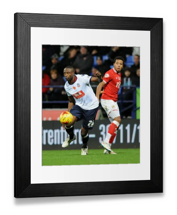 Framed Print : Shola Ameobi Slips Past Korey Smith: Intense Moment from Bolton Wanderers vs. Bristol City Championship Clash