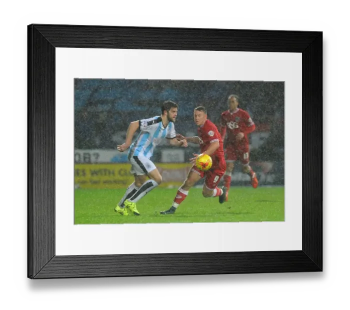 Framed Print : Bristol City's Simon Cox Closes In on Huddersfield Ball in Championship Clash Framed Print : Bristol City's Simon Cox Closes In on Huddersfield Ball in Championship Clash
