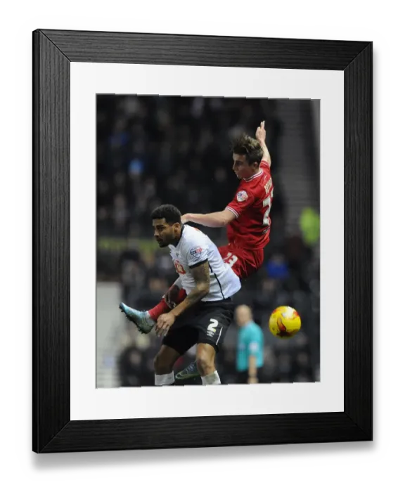 Framed Print : Bristol City's Joe Bryan Battles for a Header Against Derby County's Cyrus Christie Framed Print : Bristol City's Joe Bryan Battles for a Header Against Derby County's Cyrus Christie