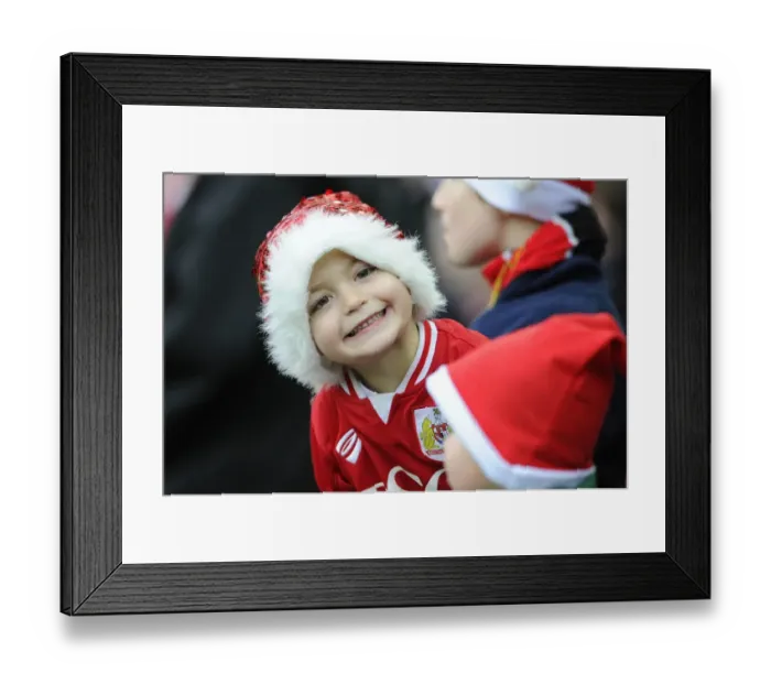 Framed Print : Bristol City Fan in Christmas Hat Celebrates at Ashton Gate during Sky Bet Championship Match against QPR, 2015