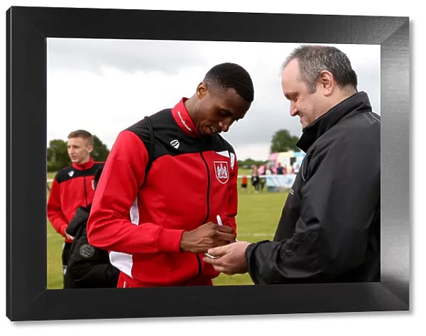 Bristol City's Jonathan Kodjia Greets Fans with Autographs at Hengrove Athletic Pre-Season Friendly
