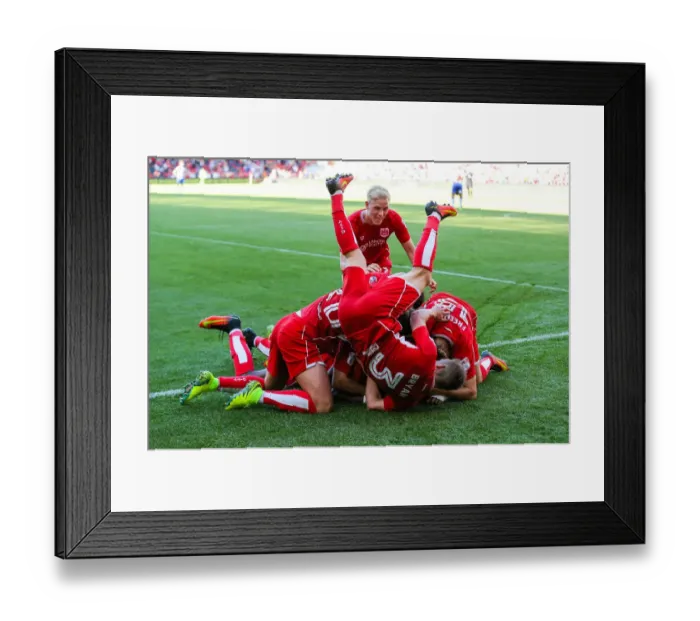 Framed Print : Bristol City's Joe Bryan Leaps Over Teammates as Bobby Reid Celebrates 2-1 Goal vs. Wigan Athletic