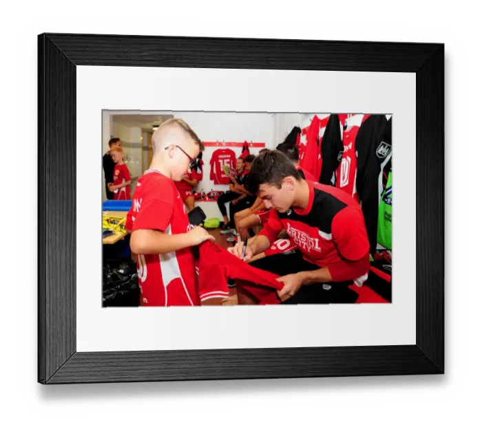 Framed Print : Bristol City's Max O'Leary Signs Autograph for Mascot in Changing Room during Bristol City v Wigan Athletic Match Framed Print : Bristol City's Max O'Leary Signs Autograph for Mascot in Changing Room during Bristol City v Wigan Athletic Match