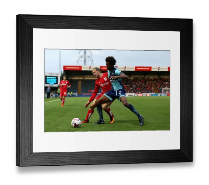 Framed Print : Battling for Supremacy: Luke Freeman vs. Sido Jombati in Wycombe Wanderers vs. Bristol City EFL Cup Clash